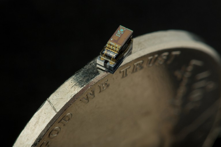 A tiny computer balanced on the edge of a coin
