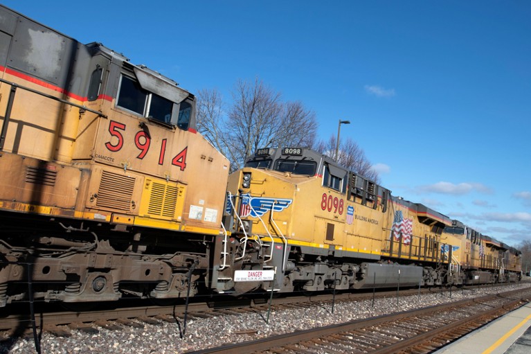A freight train being led by five locomotive units.