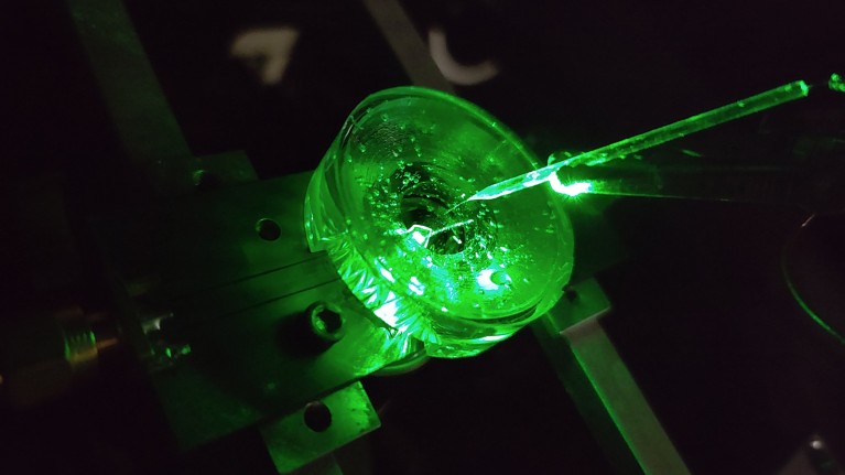 A diamond voltage imaging microscope glows green during operation