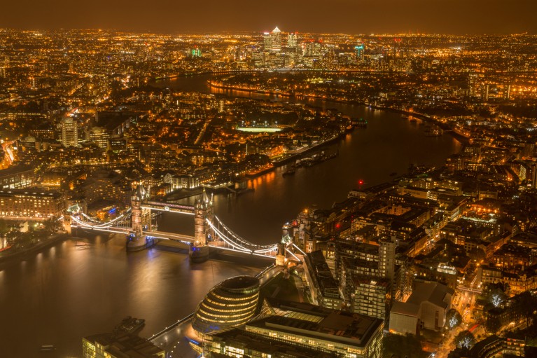 Aerial view of the River Thames and Tower Bridge in London at night