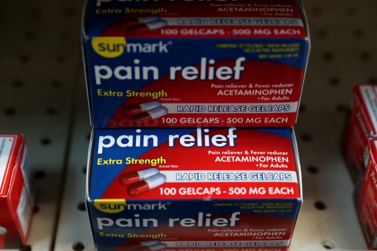 Close-up of packages of Acetaminophen displayed on a shelf in a pharmacy .