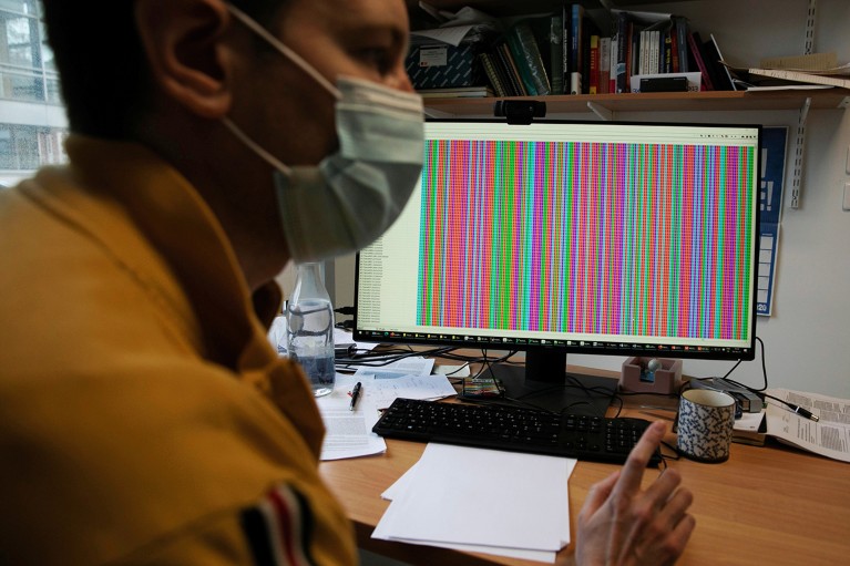 A scientist works on the sequence of the SARS-CoV-2 genome on a computer.