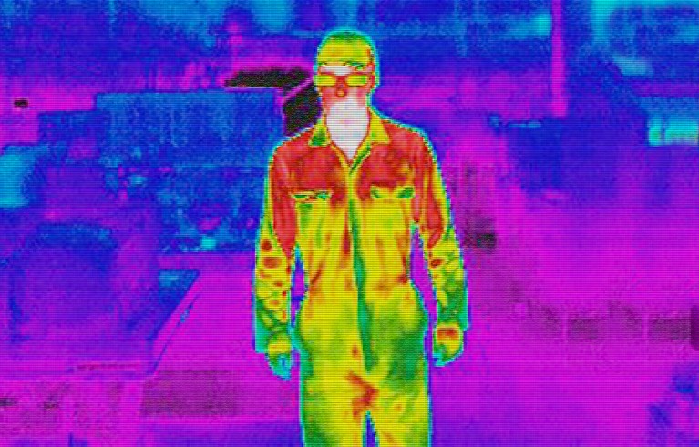 Infra red heat image of worker in factory.