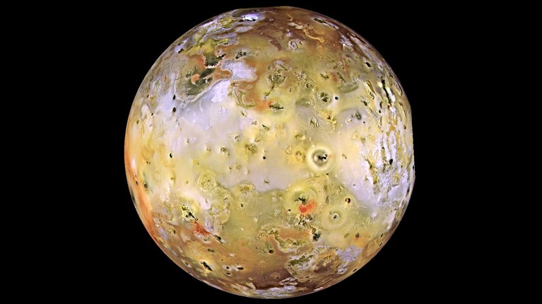 A global view of Io, covered in yellow clouds and red patches.