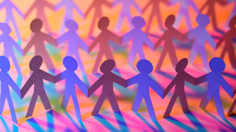 Purple and blue paper-chain human figures standing in rows