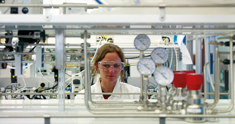 A female researcher looks at lab equipment