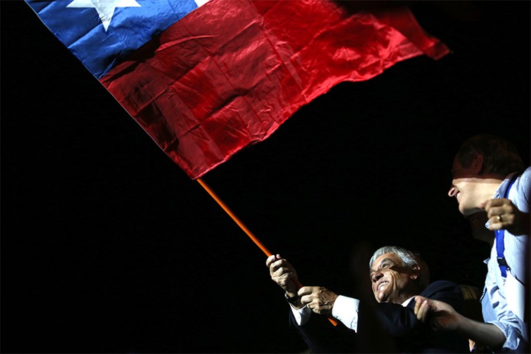 President elect Sebastian Pinera waves a Chilean flag on December 17th.