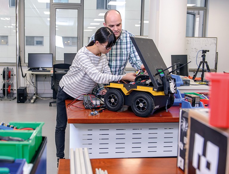 Scientists working on a robot.