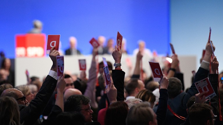 Delegates of Germany's social democratic SPD party hold up their voting cards during SPD party congress in Germany on 21.01.2018