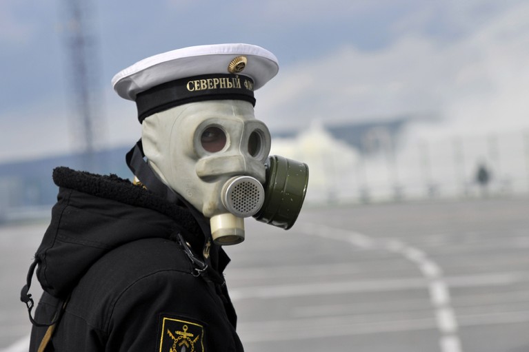 A person in a Russian military uniform and a gas mask, seen from the shoulders up.