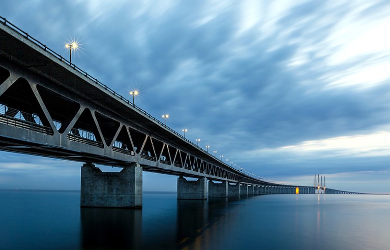 Photograph of Øresund Bridge, Europe’s longest road and rail bridge, in dim light.