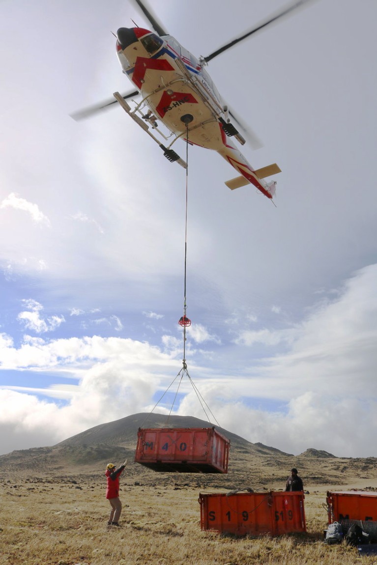 Helicopter delivering container to Marion Island
