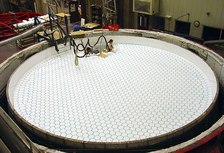 An engineer installs ceramic fibre cores within a mold that will be used to create the GMT mirror.