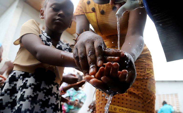 A Congolese child washes her hands as a preventive measure against Ebola in DRC, May 2018