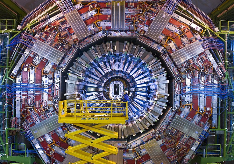 A man on a crane gazes at the CMS detector at the LHC at the end of 2007.