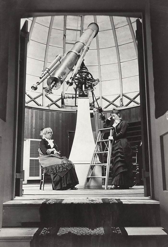 Maria Mitchell, seated at left, and her student Mary Whitney, standing at right, in front of the Fitz telescope.
