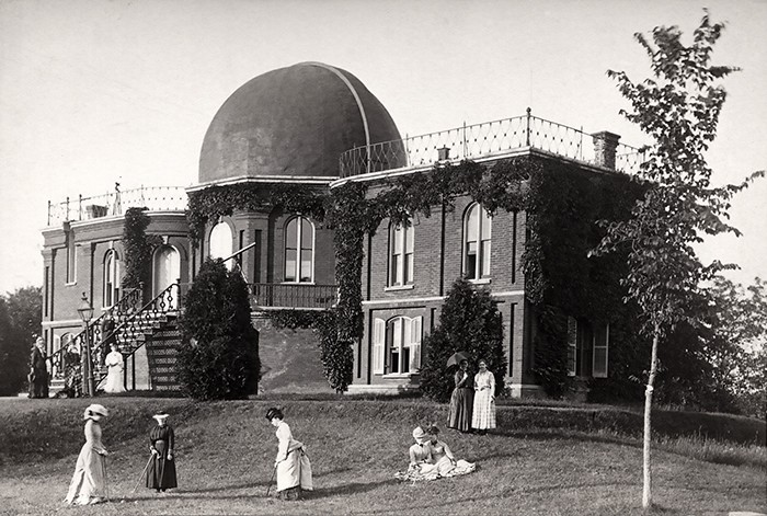 Female Vassar students walking and playing croquet on the grounds of the old observatory in 1879.