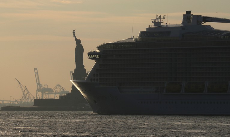 A cruise ship passes the Statue of Liberty