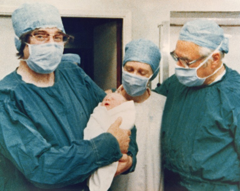 A photograph of Drs Edwards (left) and Steptoe (right) holding the first test tube baby, Louise Joy Brown.