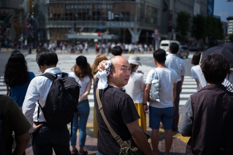 A man wipes perspiration from his head in Tokyo