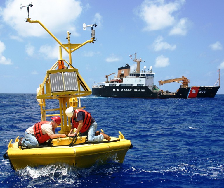 Maintenance workers on an ocean buoy