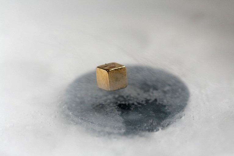 A magnet levitating above a cooled superconductor.