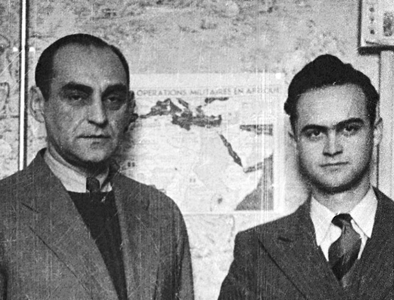 Antoni Palluth (left) and his cousin Sylwester Palluth stand in front of a chart of North African military operations