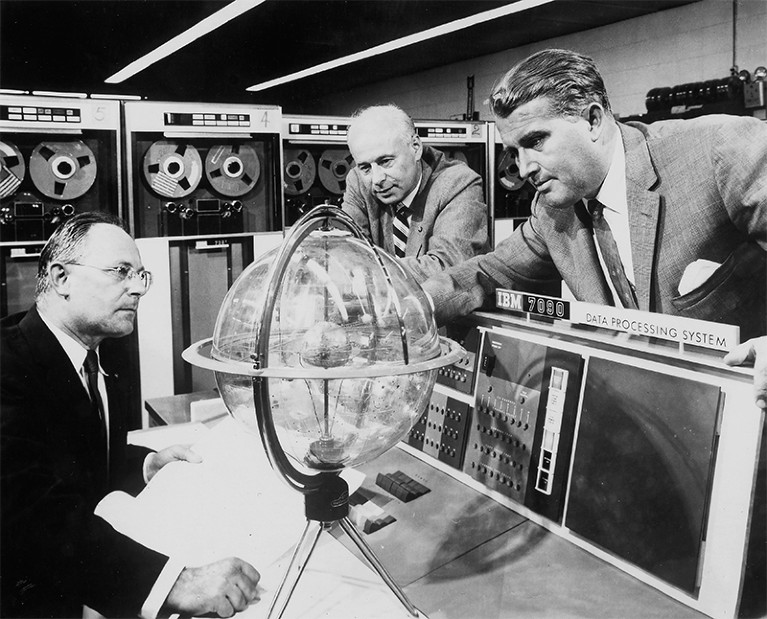 Werner von Braun (right), German born rocket pioneer, 1944, looks at scientific equipment with two other men