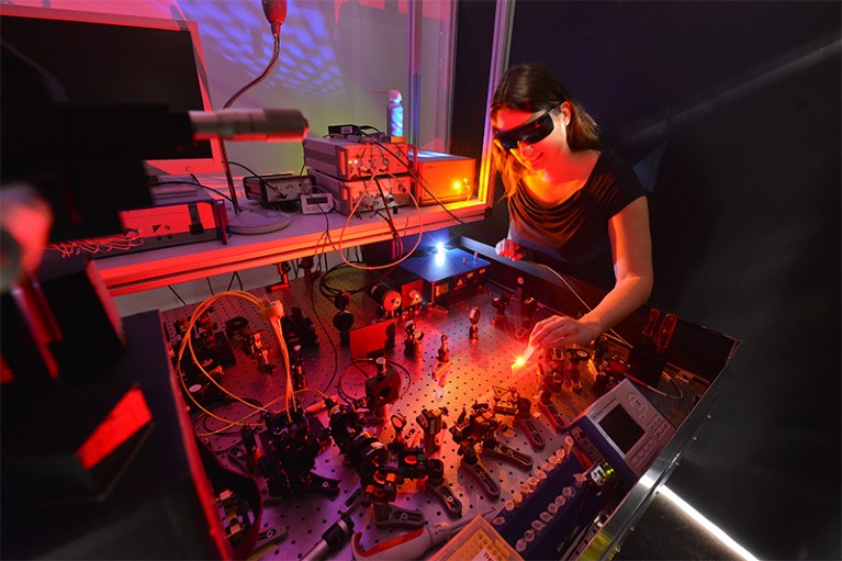 Photo of physicist at Martin Luther University using a laser