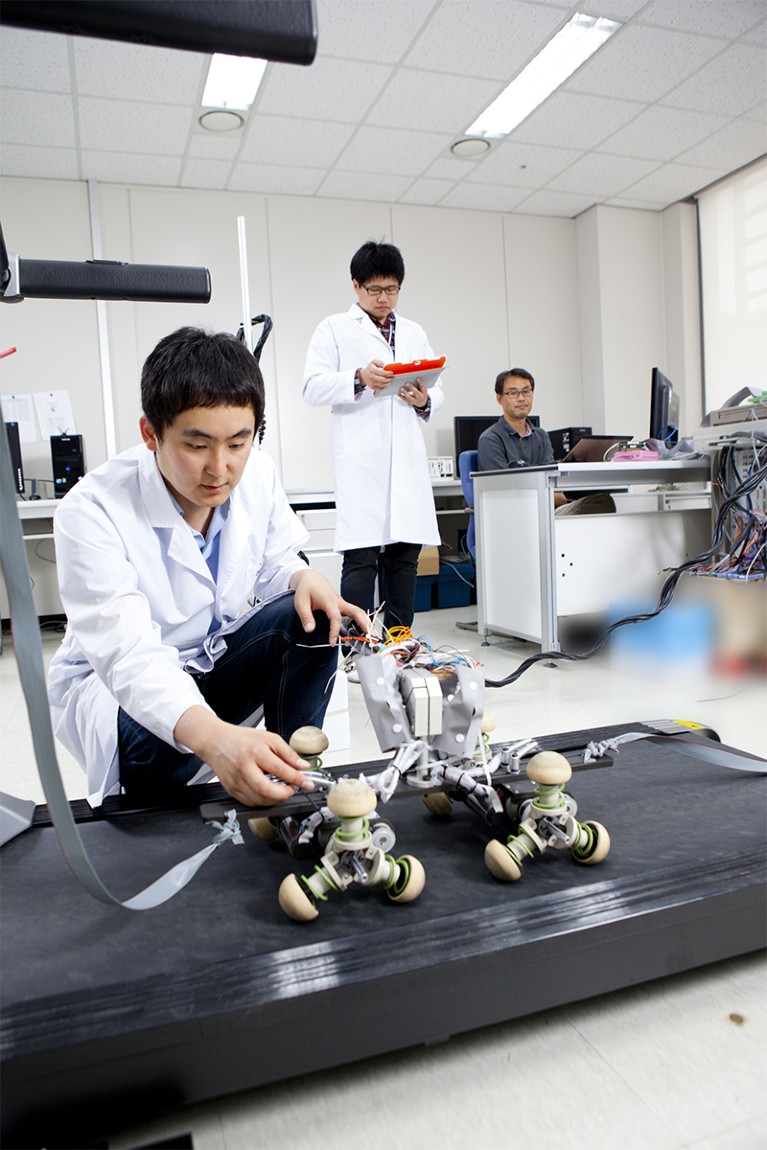 Photo of researcher with robot at Daegu Gyeongbuk Institute of Science and Technology, in South Korea