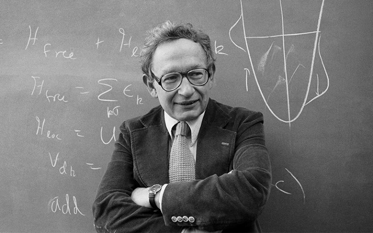 Anderson in front of a blackboard (on which are equations that helped him win the 1977 nobel prize, joint)