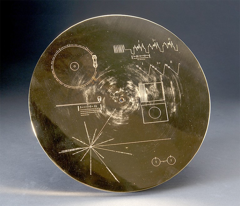 Image of a gold Voyager record with etched symbols