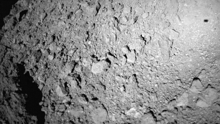 The shadow of the MASCOT lander is seen on the surface of the asteroid Ryugu