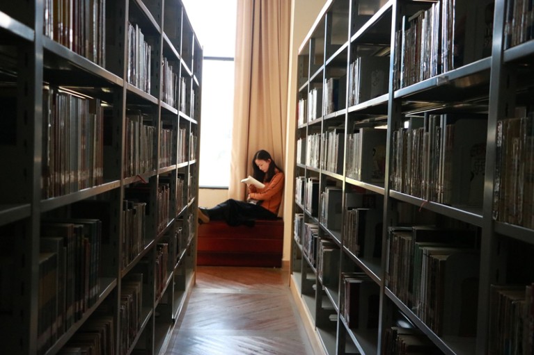A student in the Yunnan Normal University library
