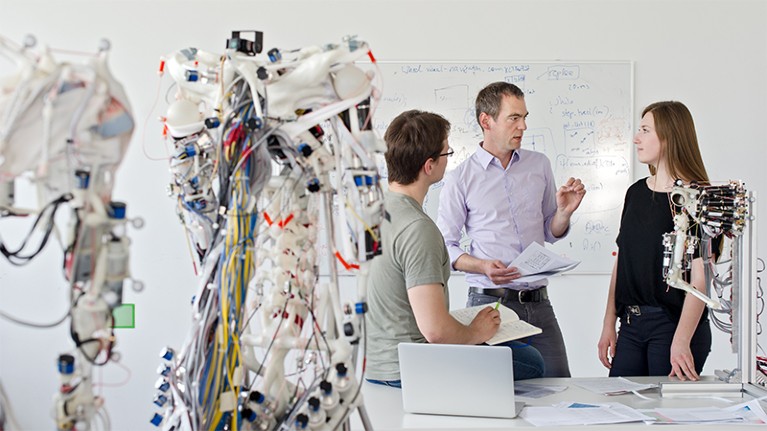 researchers working in robotics laboratory