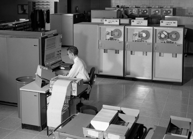 1960s Man programming mainframe computer