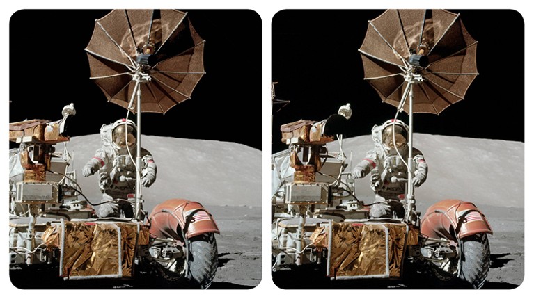 Stereoscopic image of astronaut Gene Cernan standing next to a parked lunar rover during an Apollo 17 moonwalk