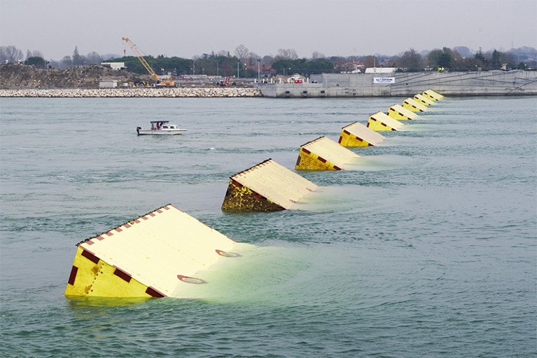 Huge yellow blocks, the gates of MOSE, emerge during technical tests in Venice's Lido in 2014