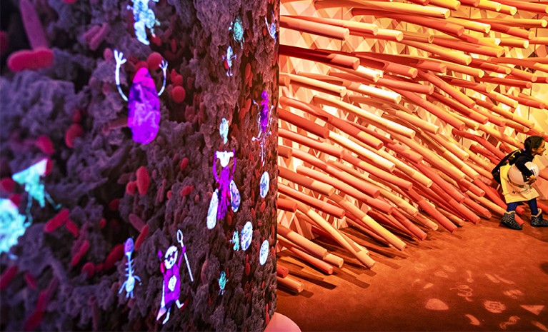 Little girl playing with installations at the 'Gut' exhibition in FranceView of the exhibition in France