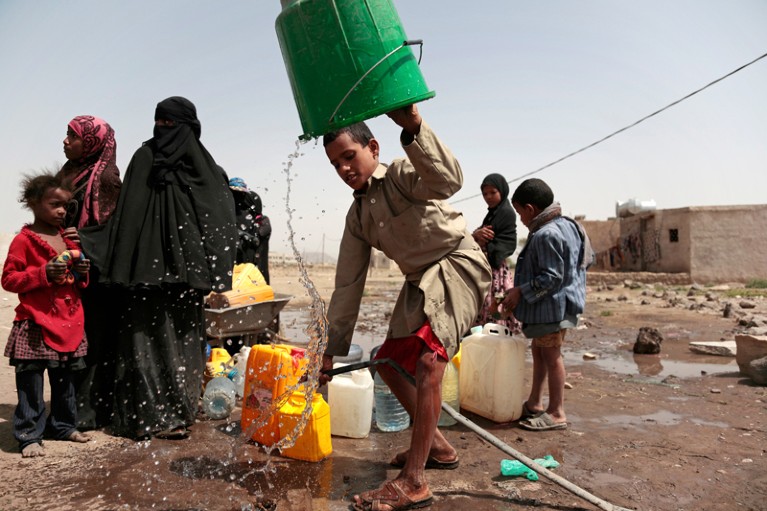 Boy collects water in Yemen