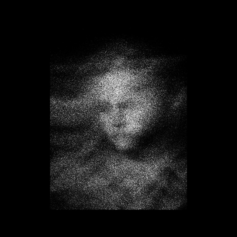 A vaguely indistinct floating face made of white spots on a black background.
