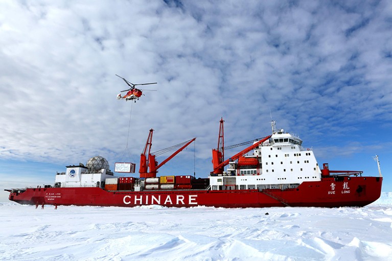 Members of the research team use the helicopter to unload cargo at the roadstead off the Zhongshan station in Antarctica.