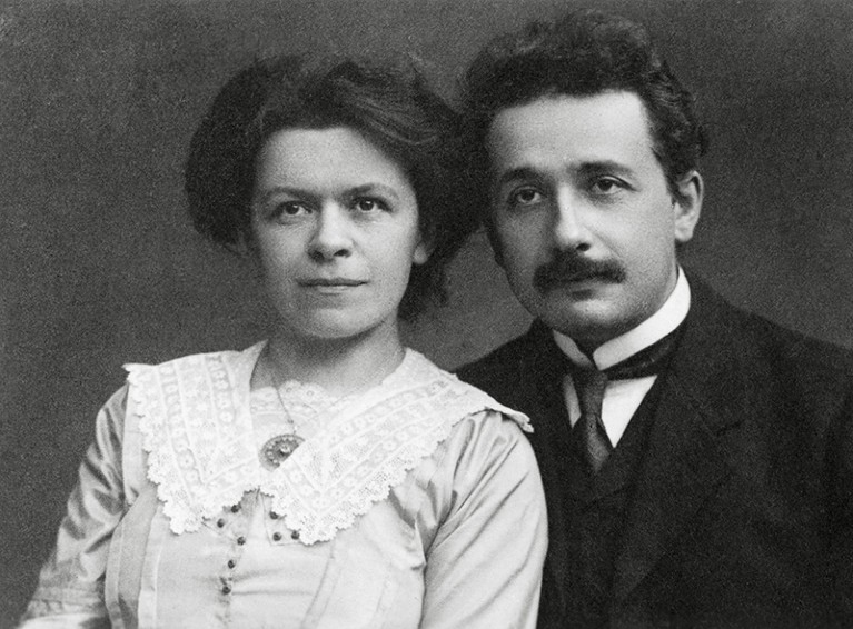 Black and white photo of young Einstein (right) and his wife in Edwardian clothes.