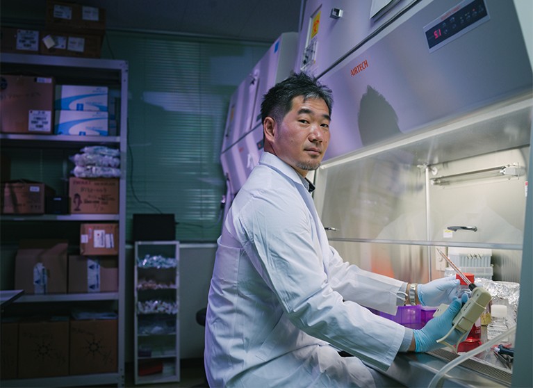 Daniel Ken Inaoka sits at a fume cupboard