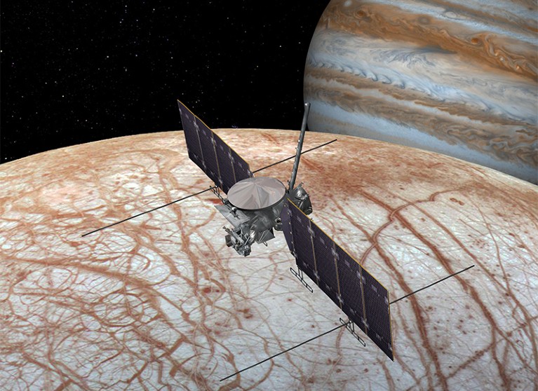 Artist's rendering showing NASA'S Europa Clipper spacecraft flying over the moon's surface with Jupiter in the background