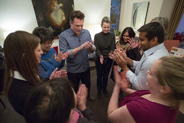 An improv class of cancer patients laughs together.