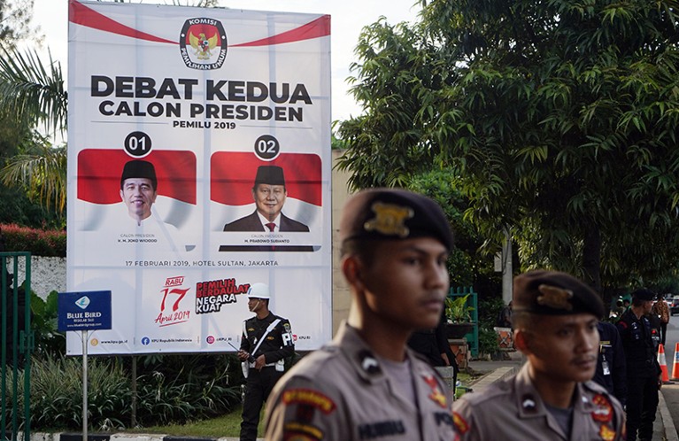 The two candidates are seen on a banner ahead of a second presidential debate in Jakarta, Indonesia