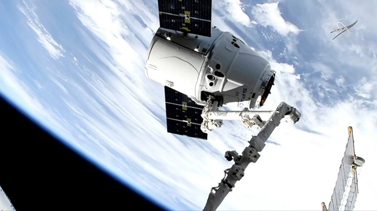 Image taken from NASA Television, a SpaceX shipment arrives at the International Space Station following a weekend launch