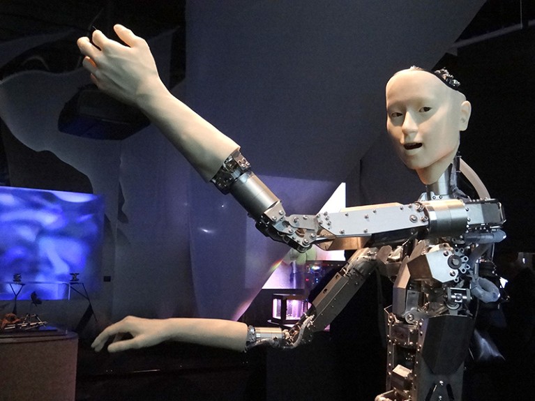 A robot with a metal body and arms, but a humanoid face and hands.