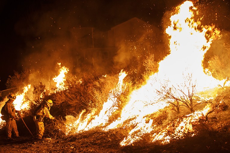 Firefighters conduct a burn operation near Lake Elsinore, California